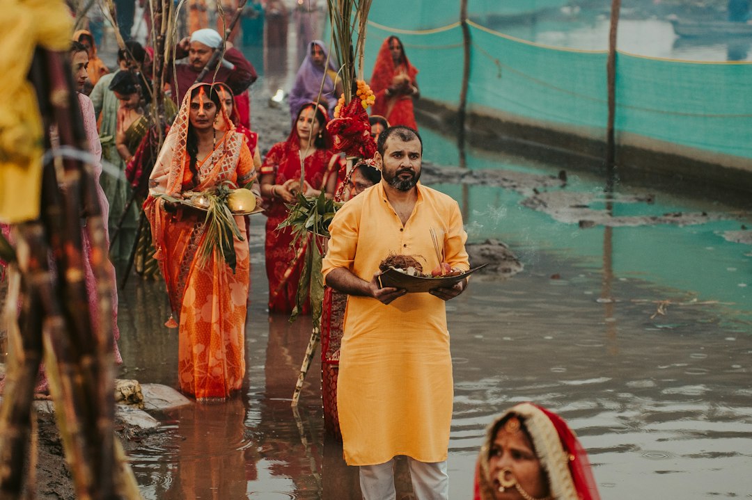 Devotees performing Tarpan ritual by the river during Pitru Paksha